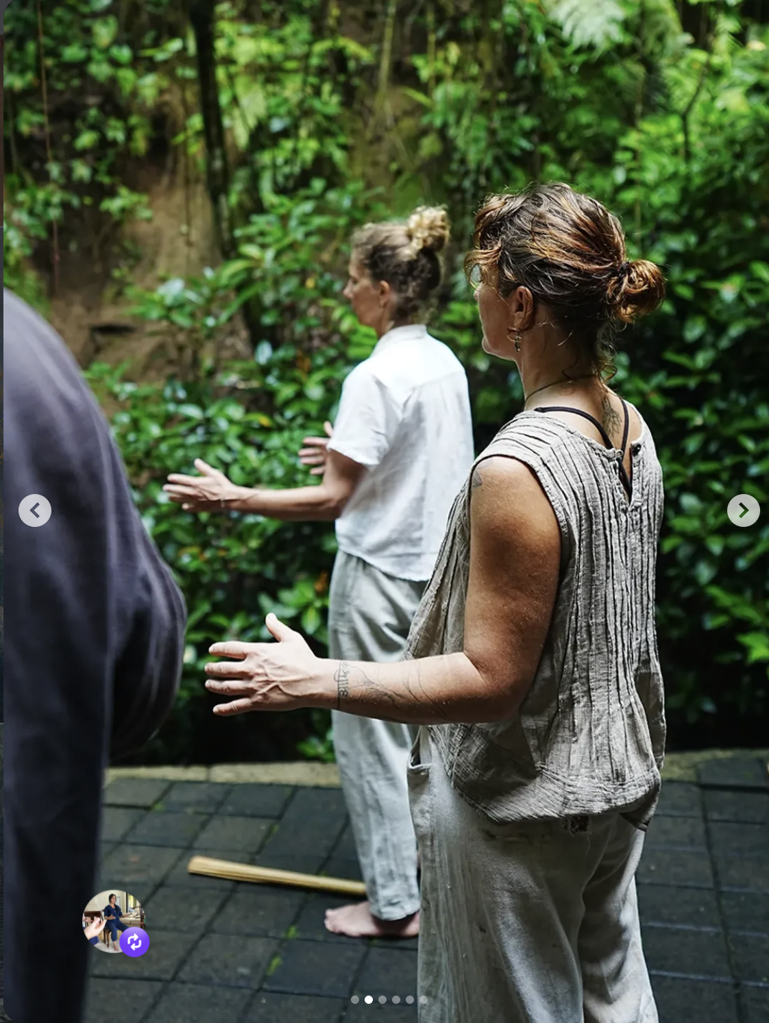 Two participants practising Qigong among trees